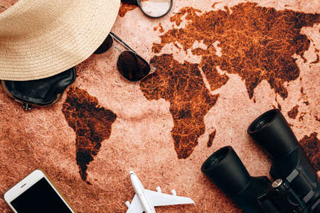 The traveler's things are laid out on the world map. High quality photoの写真素材