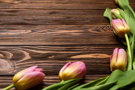 Flowers of spring tulips on the wooden boards of the table. Greeting card for mother's Day, Easter. Copy spaceの写真素材