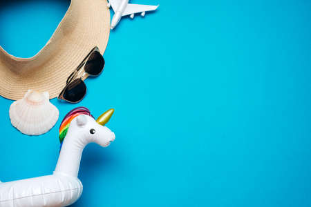 On a blue background laid out a hat, an inflatable circle sunglasses. High quality photoの写真素材
