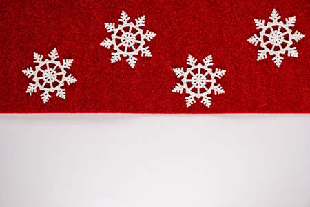 Classic red christmas ornaments decorations background with horizontal glitter snowflakes.の写真素材