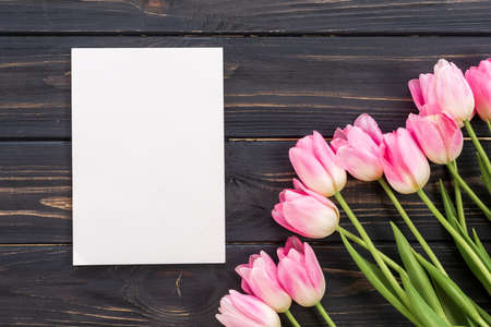 Fresh pink tulip flowers on wooden table. Top view with copy spaceの写真素材