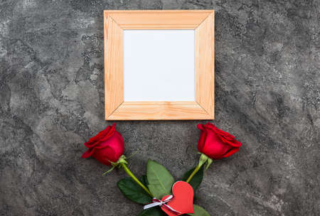 Celebrate Valentine's day. Red roses, heart sign,on grey background top view copy spaceの写真素材