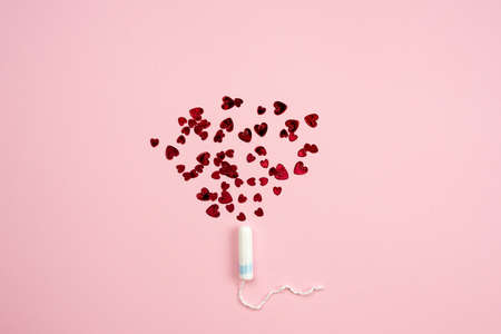 Tampon with hearts on a pink background.の写真素材