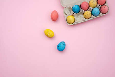 Tray with Easter eggs on pink background. Space for text. Top view.の写真素材