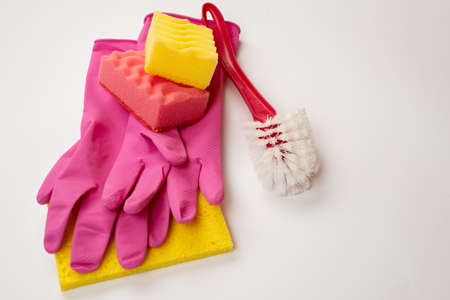 Sponge, household brush, latex gloves lying on a white background. Concept cleaning serviceの写真素材