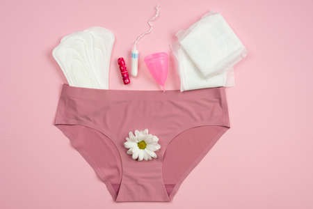 Underwear with protective equipment for critical days on a pink background.の写真素材