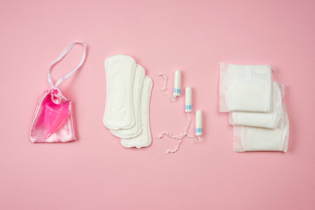Woman pads, tampons and menstrual cup  lying isolated on  pink  background.    Concept woman protectionの写真素材