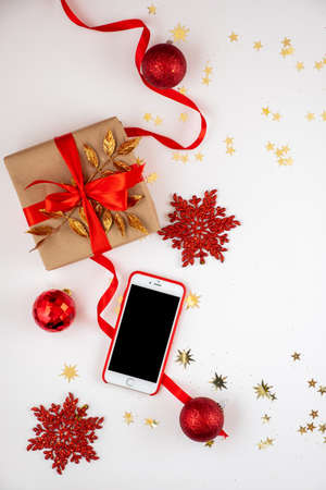Beautiful Christmas decorations and smarphone on the white background.の写真素材