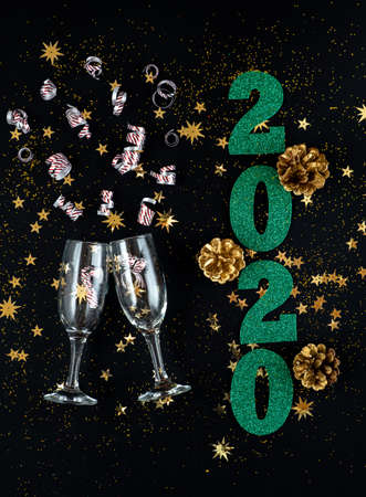 A magical time. Christmas background on black background with sequins, confetti, gold cones and...