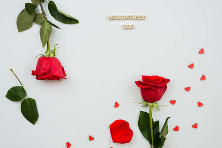 Red roses and heart shape ornaments on white backgroundの写真素材