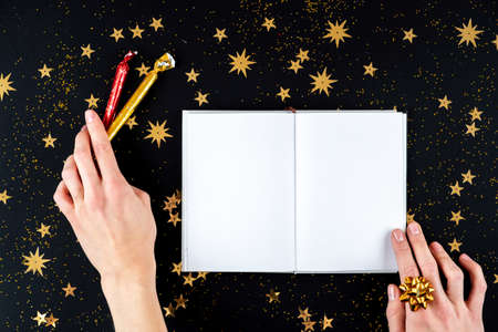 Female hands writing Christmas greeting letterの写真素材