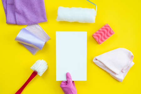 Cleaning items and a clean layout lie on a yellow background. Cleaning service concept.の写真素材