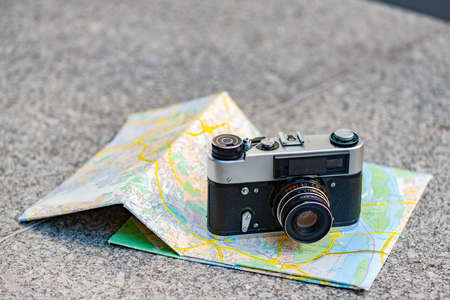 Vintage old camera on a background of old map lying on the stone  - Imageの写真素材