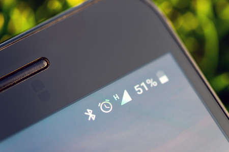 Icons in mobile phone battery, Bluetooth, alarm clock, networkの写真素材