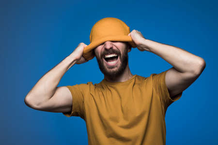 bearded man wearing yellow hat with empty space for your logoの写真素材