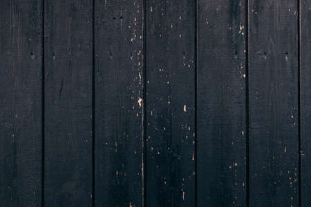 Cropped view of the black vintage wood background texture of the fence with knots and holes. Objects concept. Stock photoの写真素材