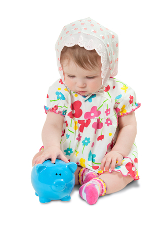child with a piggy bank on white backgroundの写真素材