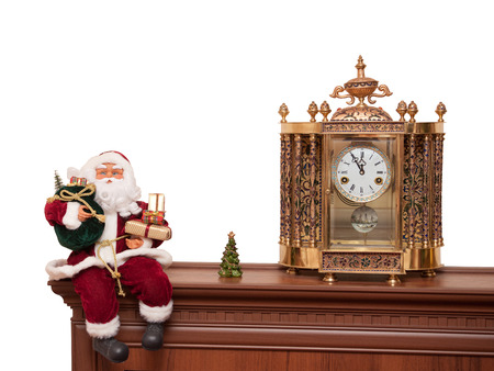 Santa Claus doll on a shelf with a clockの写真素材