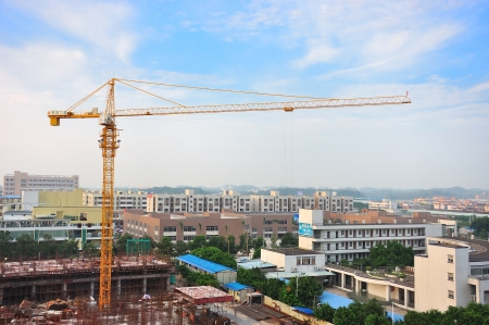 Buildings under construction and cranes under a blue skyの写真素材