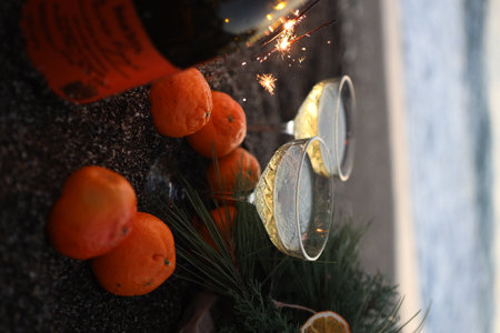 Burning a bottle of red wine and tangerinesの写真素材