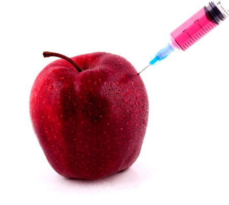 Red Apple With Syringe Injecting Color on Isolted White Backgroundの写真素材