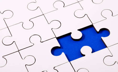 Jigsaw with piece removed revealing blue underlay