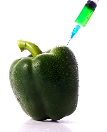 Green Pepper With Syring Injecting Color Into Itの写真素材