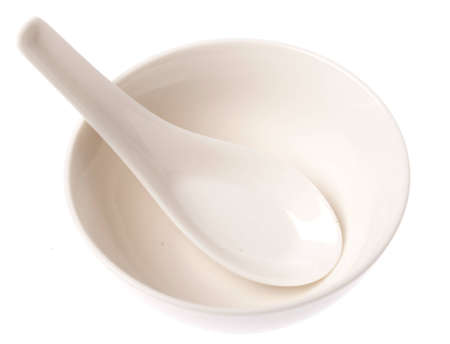 An empty asian type bowl and spoon on isolated white backgroundの写真素材