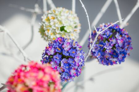 Round decorative flower balls of white, blue and pink colorsの写真素材