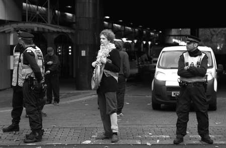 clown standing in the middle of the police line while there was a protest happening(union strike in London)のeditorial素材
