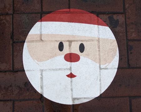 Santa Claus face on the footpath brickの写真素材