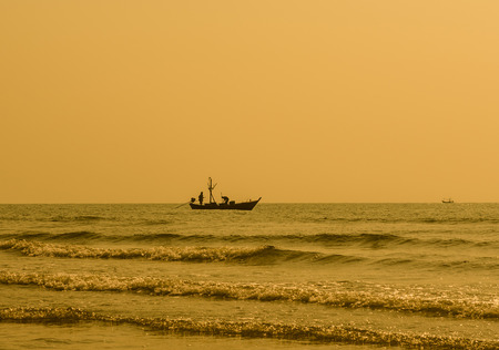 Silhouette of fisherman coming back home. hua hin Thailand.の写真素材