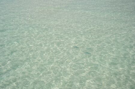 Natural turquoise beach and reflections water at Maldives island.