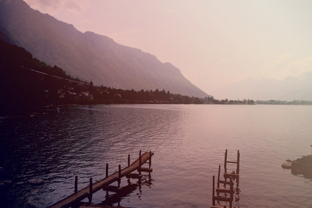 boardwalk in the lake and mountain in background. Vintage tone, Switzerland.の写真素材