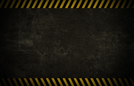 A sparse grunge wall background with caution borders.の写真素材