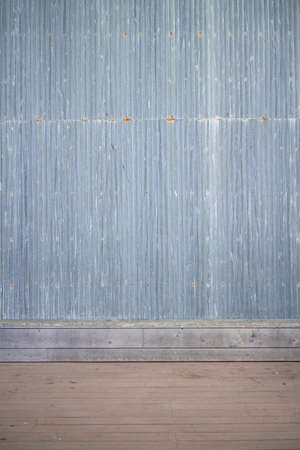 Vertical view of tall corrugated steel wall with some rust.の写真素材