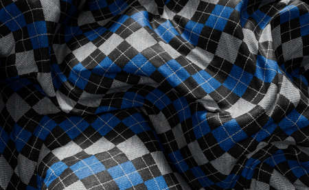 Abstract 3D rendering of blue argyle checker pattern fabric textile background.の写真素材