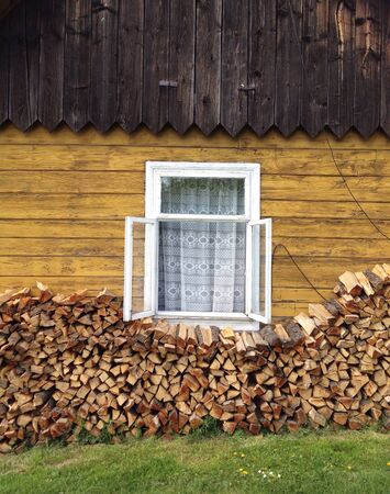 Firewood at old countryhouse's wallの素材