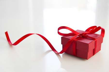 red gift box over white tableの写真素材
