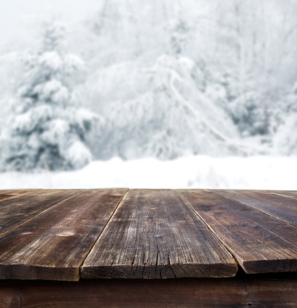 rustic table against winter landscapeの写真素材