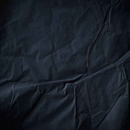 Black crumpled paper texture backgroundの写真素材