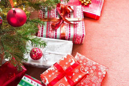 Christmas tree with gifts on red carpetの写真素材