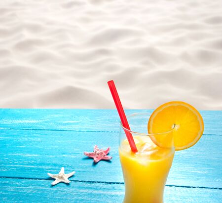 orange juice at the beachの写真素材