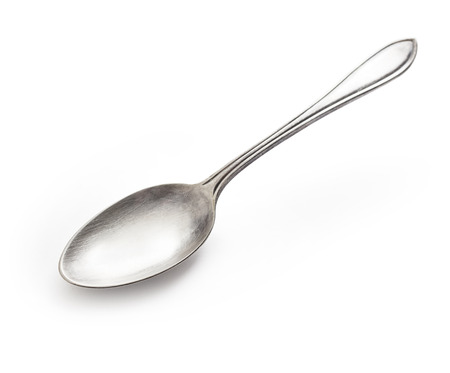 old silver spoon isolated on whiteの写真素材