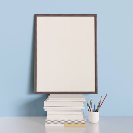 Mock up poster standing on a stack of books. Blue wall background and white desk. 3D render. 3D illustration.の写真素材