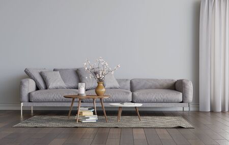 Living room interior with gray sofa and two coffee tables on the carpet. Empty gray wall mockup. A pile of books on the carpet, a candle and flowers on the table. 3D render. 3D illustration.の写真素材