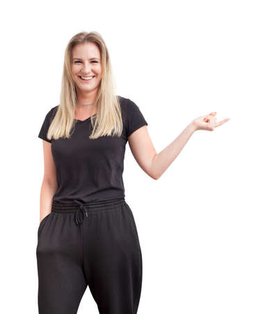Young, attractive, cute woman with long hairs, wearing black casual clothes pointing finger on copy space. Beautiful female model photography isolated on white background.の写真素材