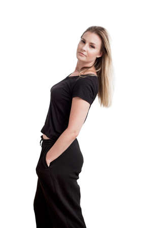 Young, attractive, cute woman with long hairs, wearing black casual clothes. Beautiful female model photography isolated on white background.の写真素材