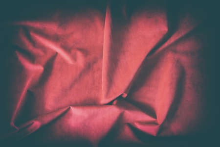 old red rippled fabric for background, wavy foldsの写真素材
