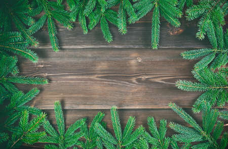 Christmas decoration. Fir tree frame on rustic, wooden background. High angle view.の写真素材